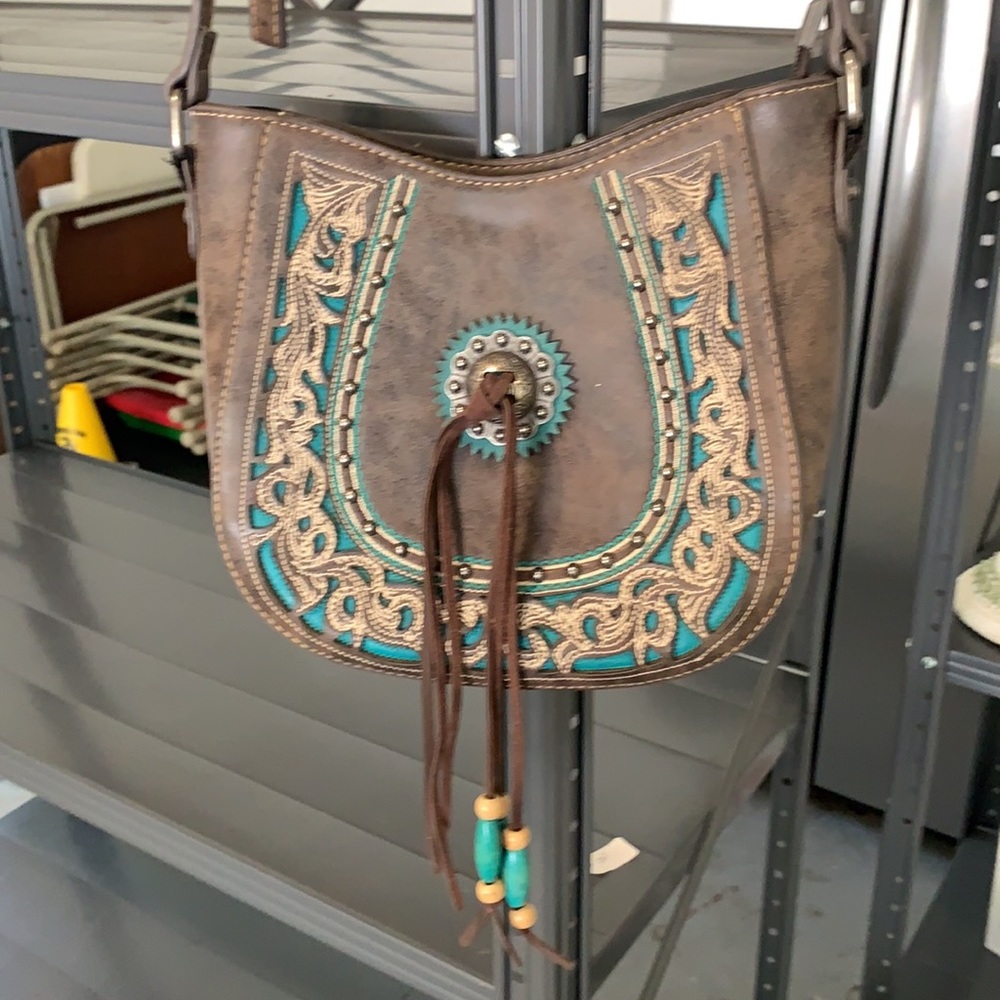Montana west purse with teal accents and fringe.